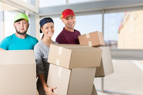 Professional movers handling office equipment safely